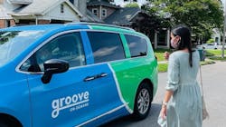 A women walking towards a Groove On-Demand vehicle. A women walking towards a Groove On-Demand vehicle.