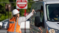 Metro-North employee Karen Miele hands out safety pamphlets to motorists stopped at a Metro-North crossing. Metro-North employee Karen Miele hands out safety pamphlets to motorists stopped at a Metro-North crossing.