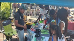 GoTriangle employee shares information on public transit and services at the 18th Annual North Carolina Juneteenth Celebration in Durham.