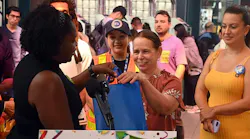 Candida Alfonso receiving her gift bag for being the 1 billionth taper on OMNY.