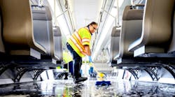 Train car cleaner Alyssa Barnes mops the floor of a BART car with disinfectant soap and steaming hot water during a train car thorough clean.