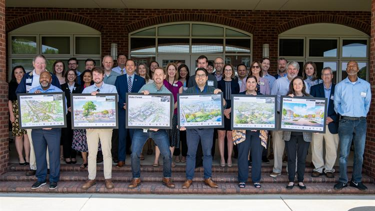 &NegativeMediumSpace;&NegativeMediumSpace;&NegativeMediumSpace;Representatives from partner communities received TOD 'playbooks' and development renderings at a May 2023 meeting in Apex.