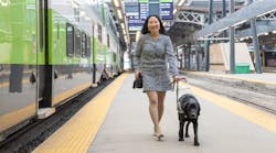 Woman_with_service_dog_on_platform.jpg