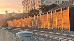 The wall built to protect the rail line below the Casa Romantica slope.