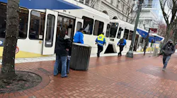 Members of TriMet's Community Safety Team checking a train in downtown Portland, Ore., in April 2023.
