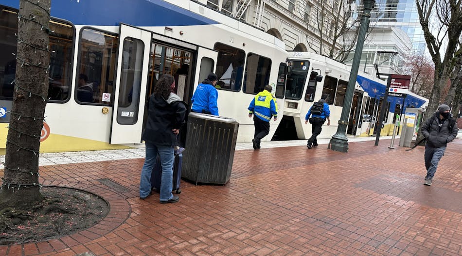 Members of TriMet&apos;s Community Safety Team checking a train in downtown Portland, Ore., in April 2023.