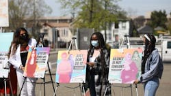 Youth activists with posters at launch of Not One More Girl campaign in 2021.