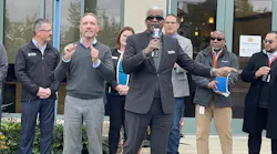 SMART General Manager Dwight Ferrell speaks to media with Oakland County Executive Dave Coulter in front of First Merchants Bank in Novi.