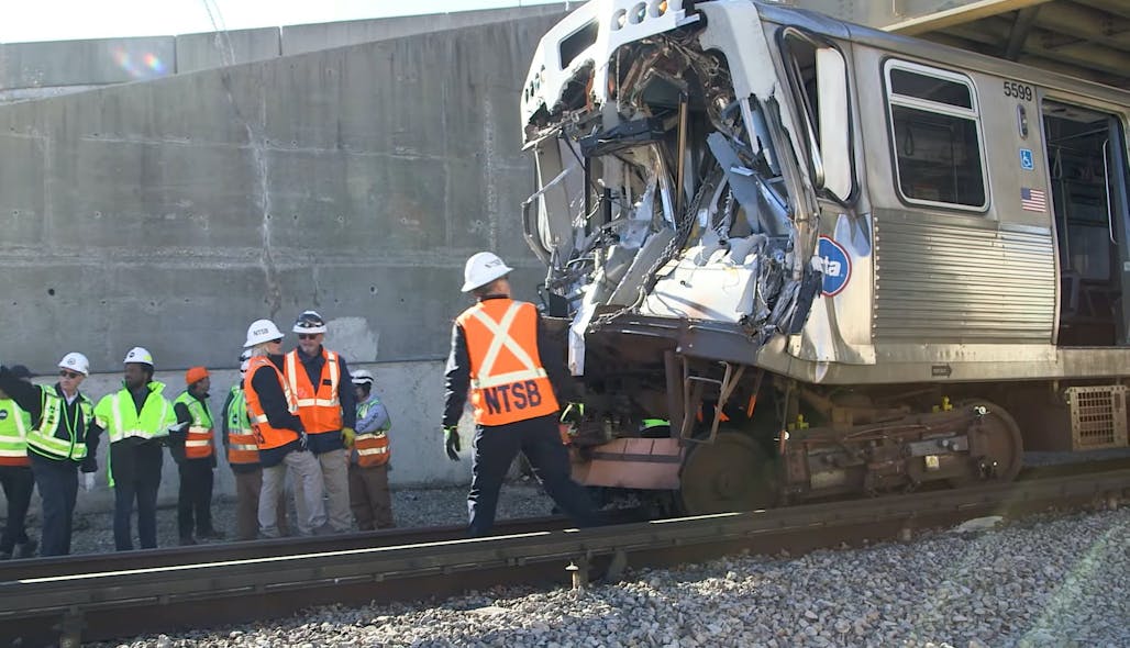 NTSB investigators and CTA employees examine the site of the Nov. 16 accident where a CTA Yellow Line train collided with a piece of snow equipment.
