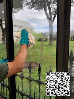 Cleaning of a BRTA shelter with QR code to graffiti cleaning video.