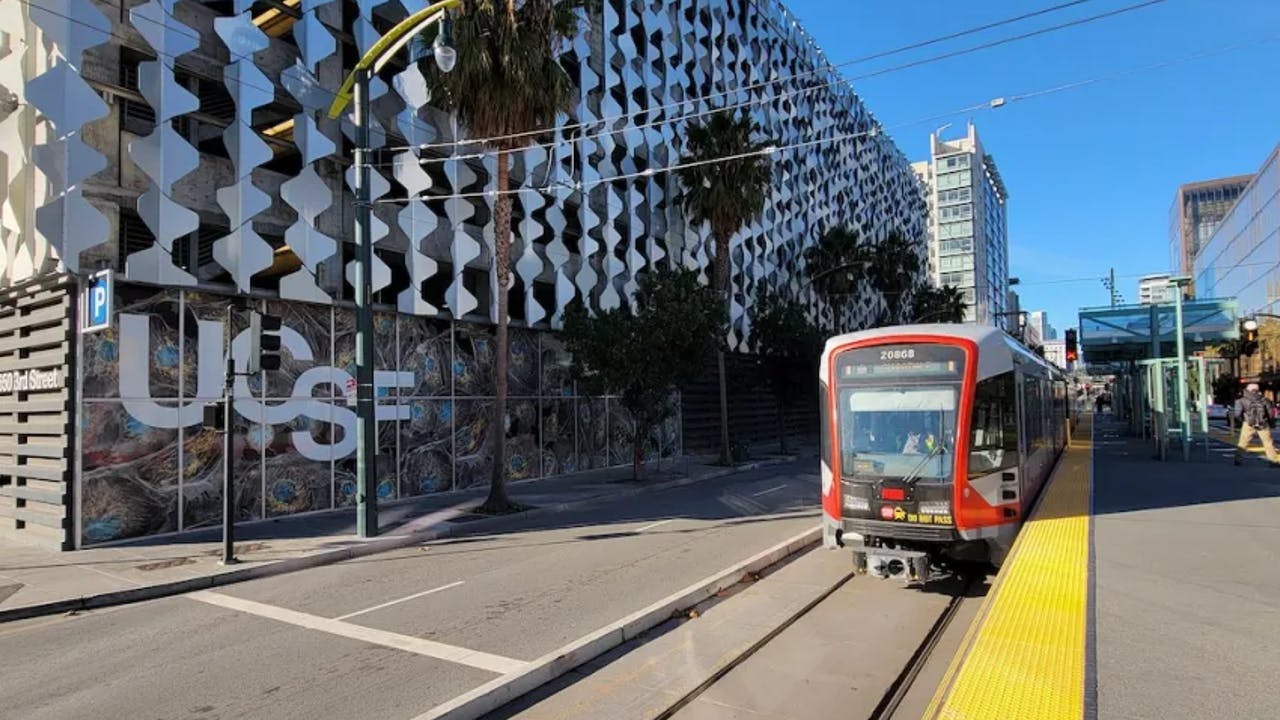 SFMTA muni cable car riding alongside UCSF.