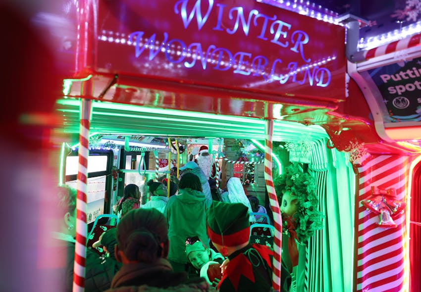 Santa Claus waves to children and parents on the CTA Holiday Bus on Dec. 8, 2023.