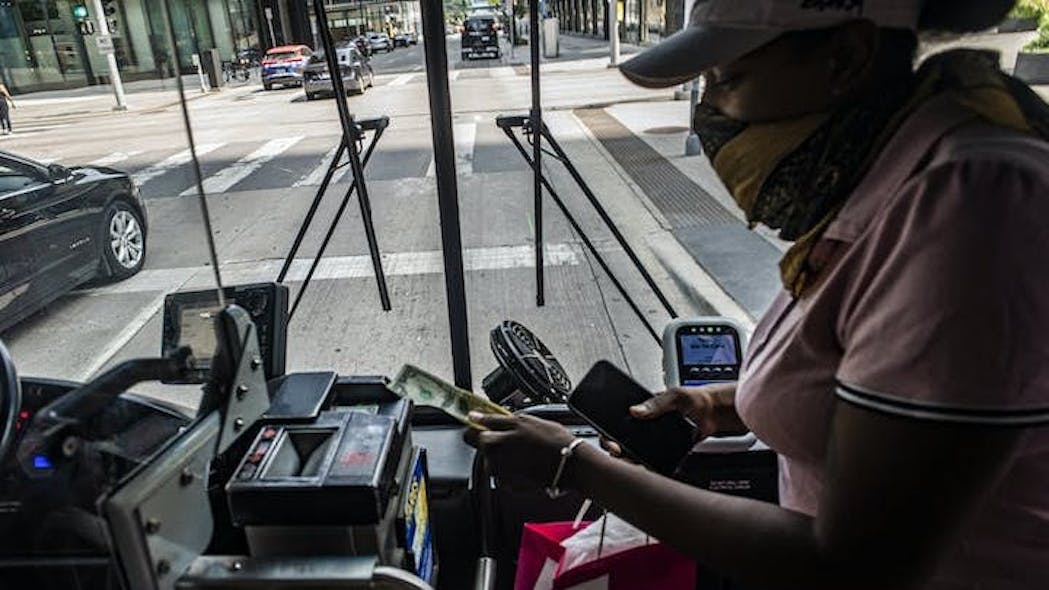 A rider puts cash into a Metro Transit farebox. The agency plans to upgrade validators on buses and trains to allow customers to pay with a credit card. RICHARD TSONG-TAATARII richard.tsong-taatarii@startribune.com