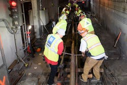 Track crew moving new rail into position by hand in Van Ness Crossover during Fix It Week early subway shutdown. Track crew moving new rail into position by hand in Van Ness Crossover during Fix It Week early subway shutdown.