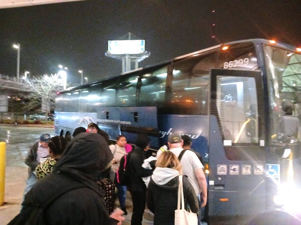 Passengers at Milwaukee Intermodal Station board a bus for Chicago in September 2023.