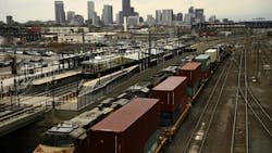 DENVER, CO - MAY 9: Trains and RTD with downtown Denver behind from the pedestrian bridge at the 38th and Blake station. May 9, 2017, Denver, Colorado.