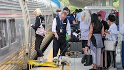 Amtrak passengers board a train to West Palm Beach and Miami at Union Station on Monday in downtown Tampa.