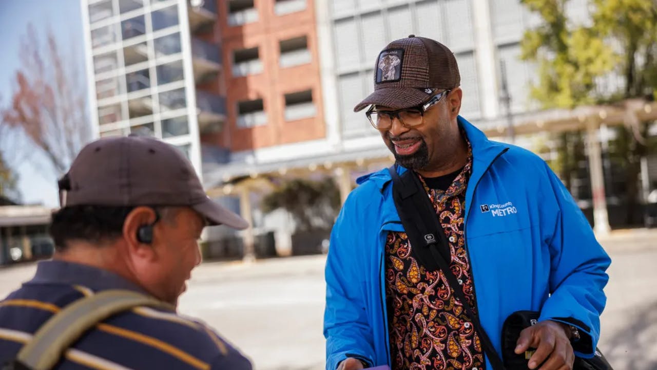 A Metro Ambassador interacts with a transit rider on April 27, 2023.