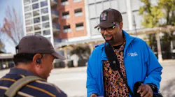 A Metro Ambassador interacts with a transit rider on April 27, 2023.
