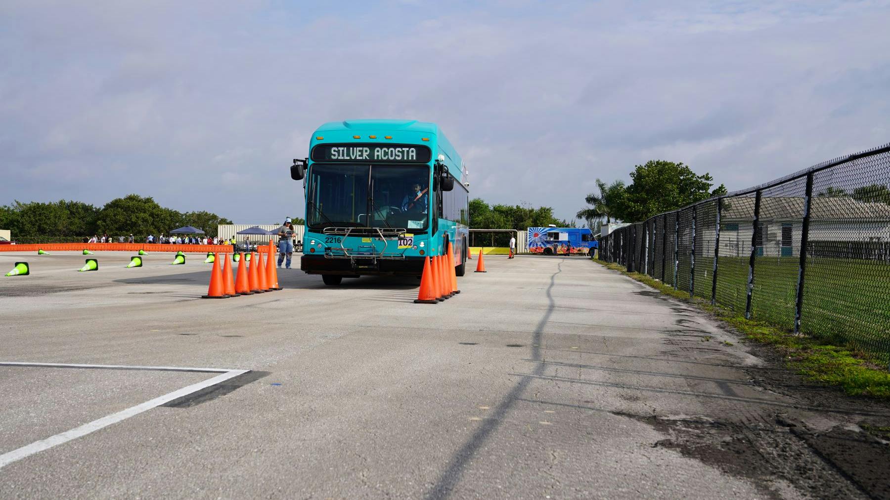 Bus going through cones.