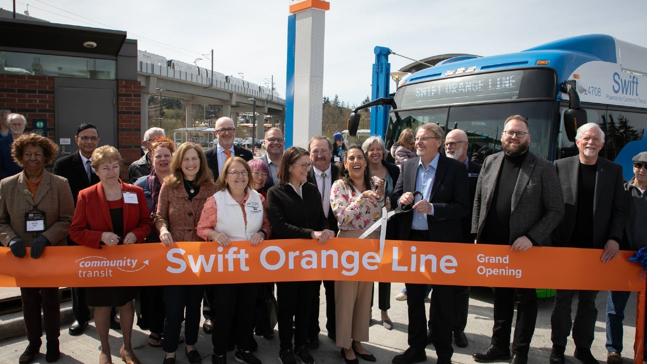FTA Acting Administrator Veronica Vanterpool holds scissors for ribbon-cutting at Community Transit Swift Orange Line opening ceremony at Lynnwood Transit Center.