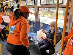 An SFMTA staffer teaches a rider how to report harassment and other issues.