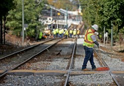 Boston, MA - October 17: Workers repair the tracks near the Ashmont MBTA Station.