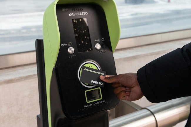 A PRESTO Card being swiped against a PRESTO fare reader.