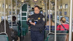 Transit Fare Inspector Veronica Lujan checks fare compliance on the F Market line.. Transit Fare Inspector Veronica Lujan checks fare compliance on the F Market line..