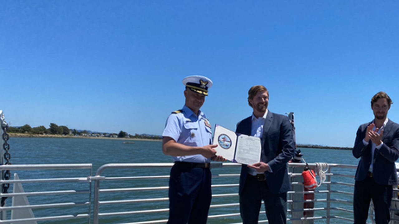 Captain Taylor Q. Lam presents Pace Ralli, CEO of SWITCH Maritime, with signed Certificate of Inspection.