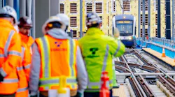 Sound Transit employees greet an approaching test train operator during a station tour in March 2024.