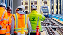 Sound Transit employees greet an approaching test train operator during a station tour in March 2024. Sound Transit employees greet an approaching test train operator during a station tour in March 2024.
