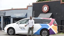 A Metro Flex driver smiles while parked next to South Park Suds Laundromat. A Metro Flex driver smiles while parked next to South Park Suds Laundromat.