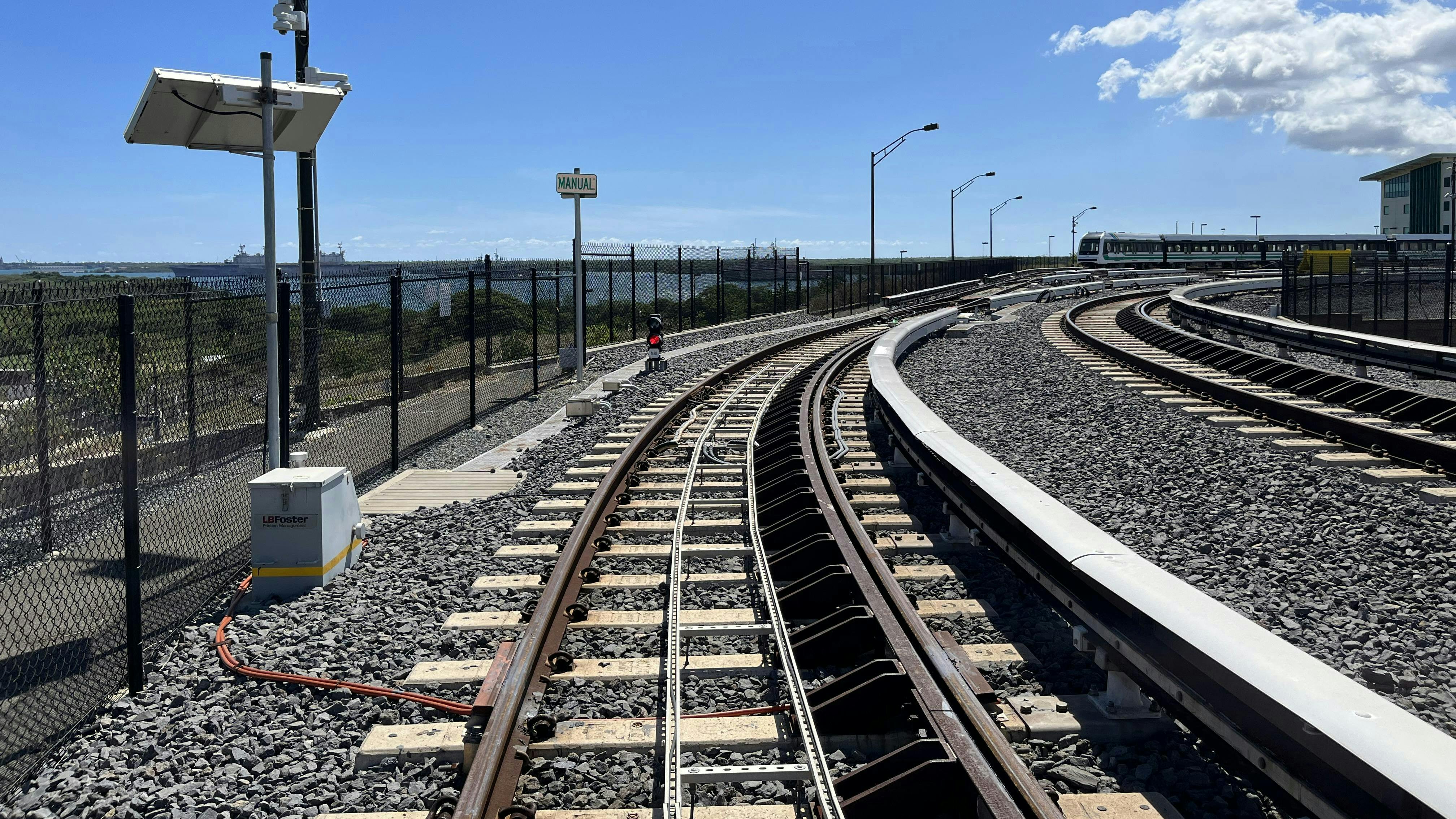 A top of rail friction management system installed on transit track.