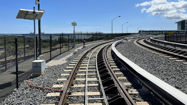 A top of rail friction management system installed on transit track.