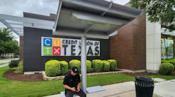 A resident waiting at one of DART's Next Generation Bus Shelters.