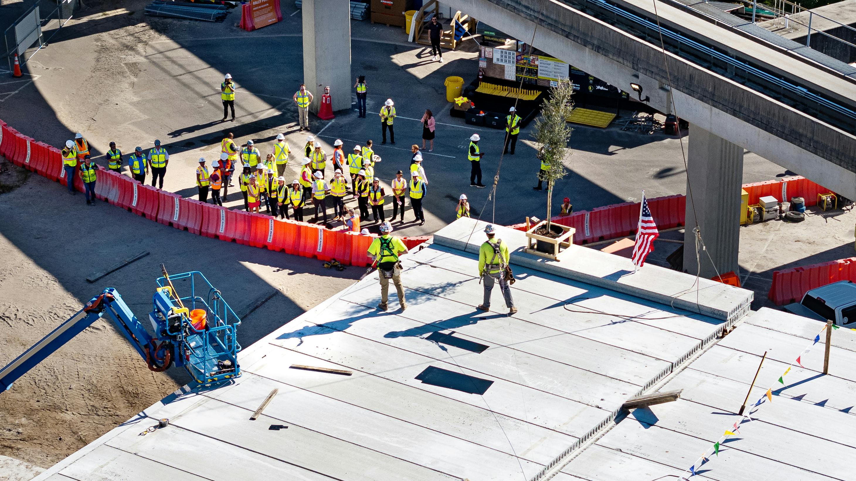 The topping out ceremony signified the last structural beam being raised into place.