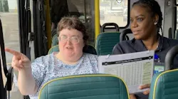 Two people sitting on a bus.