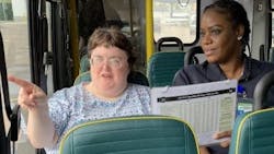 Two people sitting on a bus. Two people sitting on a bus.