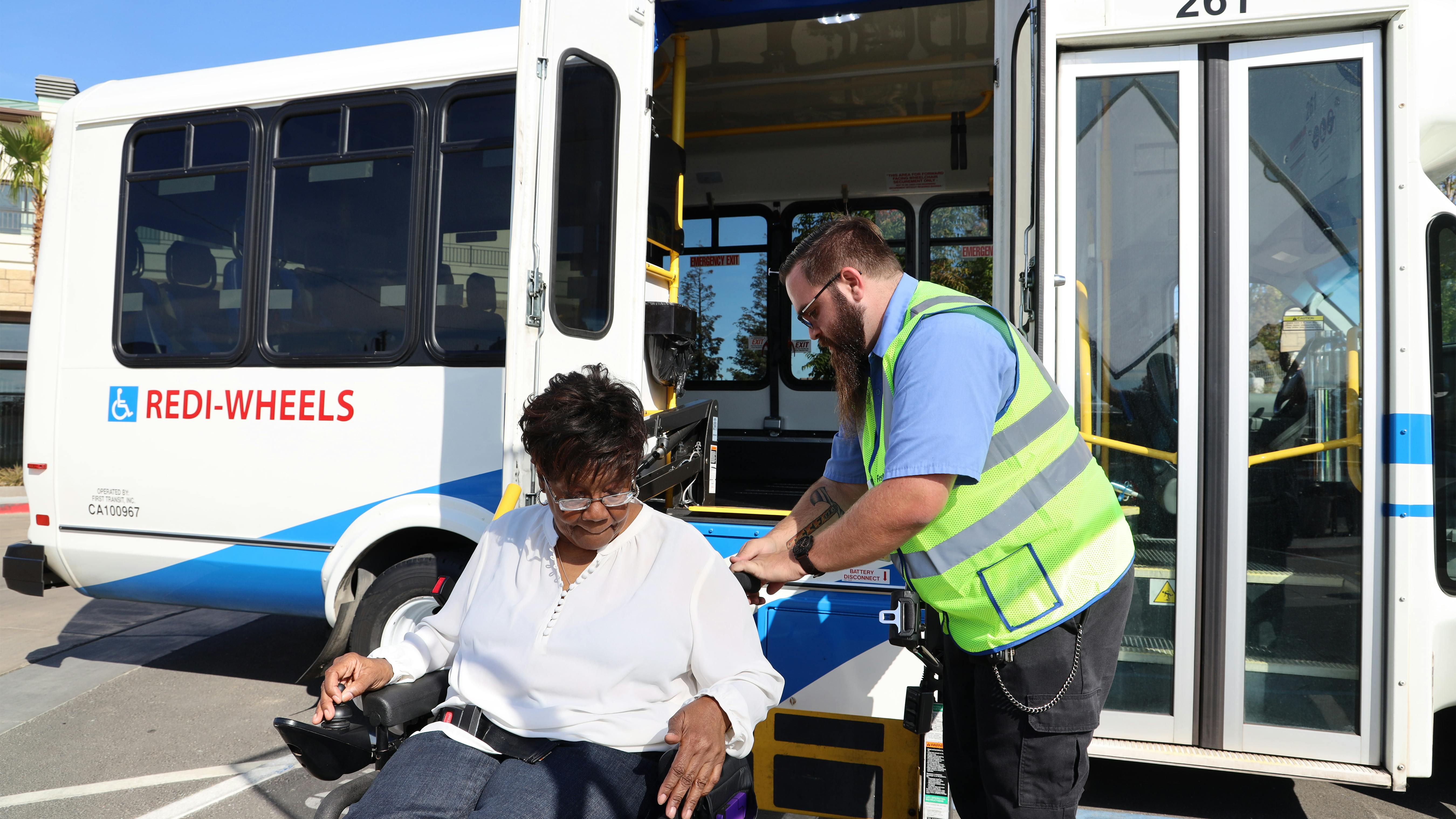 A passenger being let go off of a SamTrans paratransit vehicle.