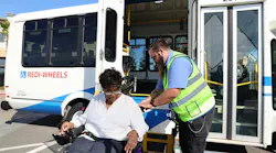 A passenger being let go off of a SamTrans paratransit vehicle.