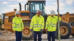 Construction workers wearing high-visibility uniforms. Construction workers wearing high-visibility uniforms.