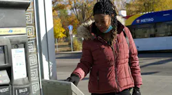 A rider tapping her card on a Metro Transit bus in Minneapolis.