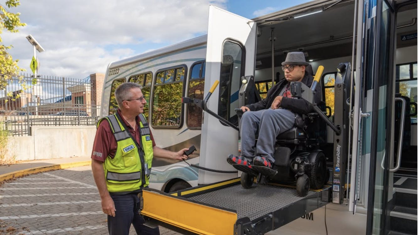 a RIde passenger disembarks the paratransit van in a wheelchair