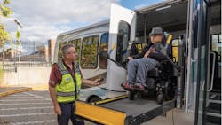 a RIde passenger disembarks the paratransit van in a wheelchair a RIde passenger disembarks the paratransit van in a wheelchair
