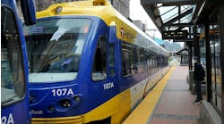 A Metro Transit blue light rail train pulls up to a station A Metro Transit blue light rail train pulls up to a station