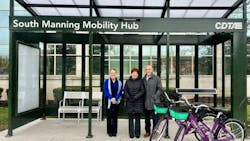three people stand outside of manning blvd mobility hub entrance three people stand outside of manning blvd mobility hub entrance