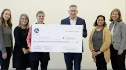 FTA Region 10 Administrator poses with king county executive holding big check