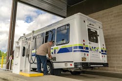 man fills up DART cutaway bus at a fuel dispenser man fills up DART cutaway bus at a fuel dispenser