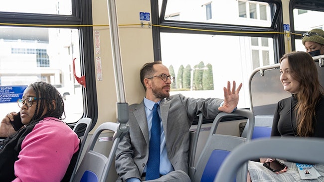 Nashville Mayor Freddie O’Connell talking to residents on a transit bus.